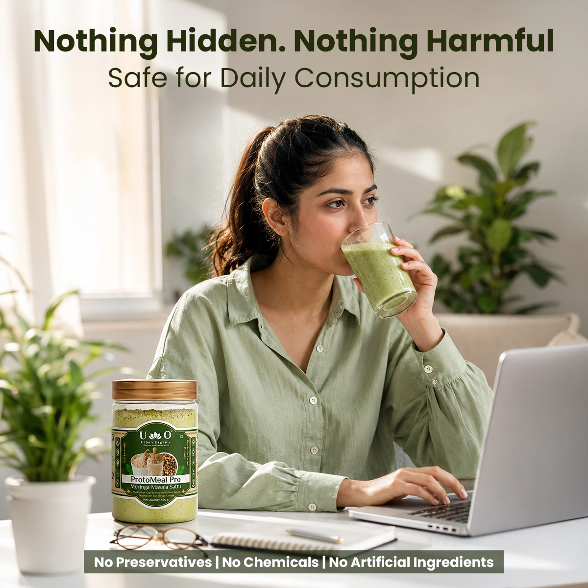 Woman working at a laptop while drinking healthy, chemical-free Urban Organic Moringa Masala Sattu