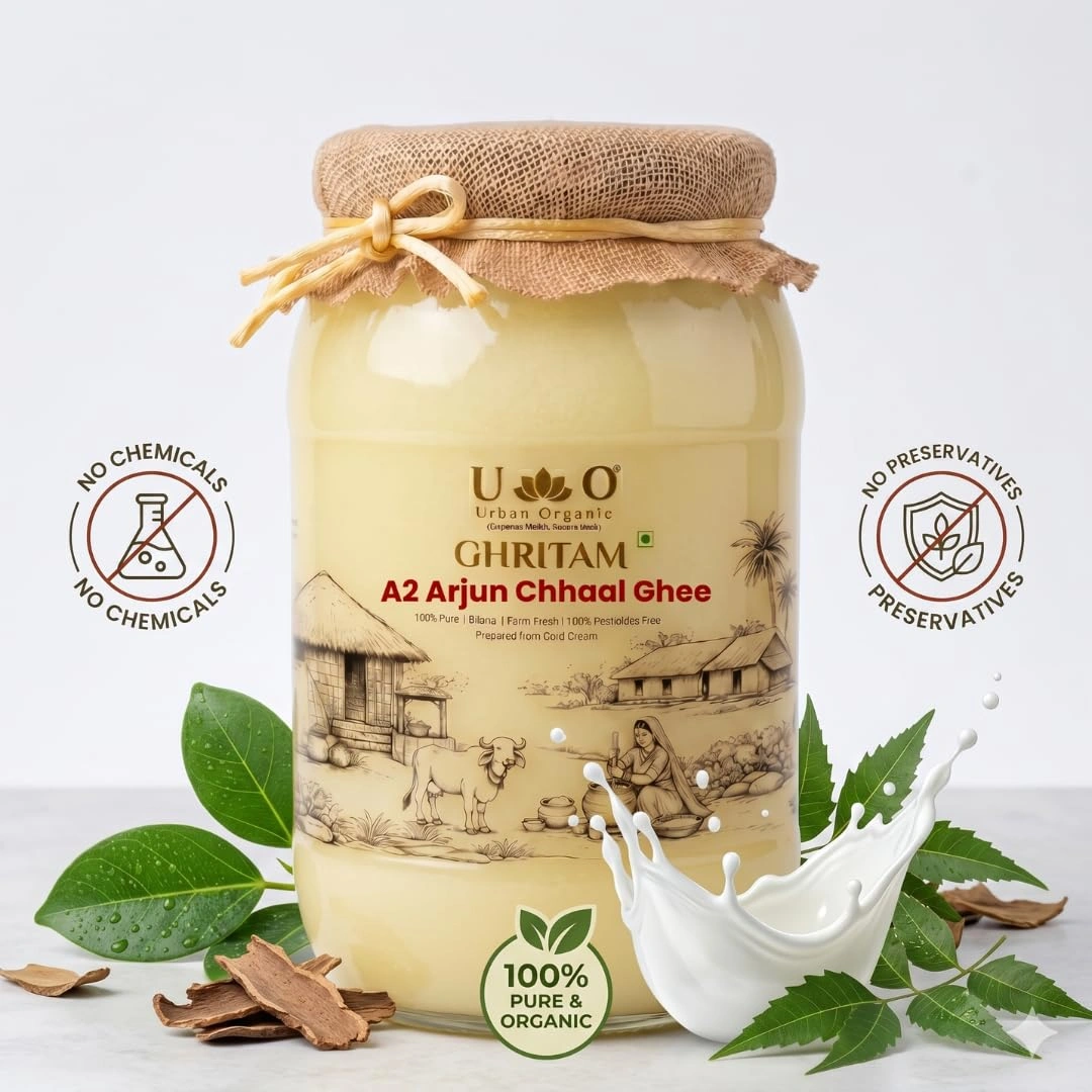 Urban Organic A2 Arjun Chhaal Ghee jar surrounded by fresh leaves, Arjun bark, and a splash of pure milk